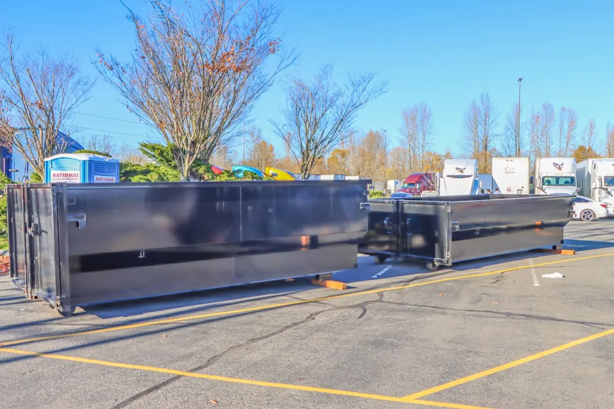 Professional dumpster rental service with roll-off container on residential driveway in Morris Plains